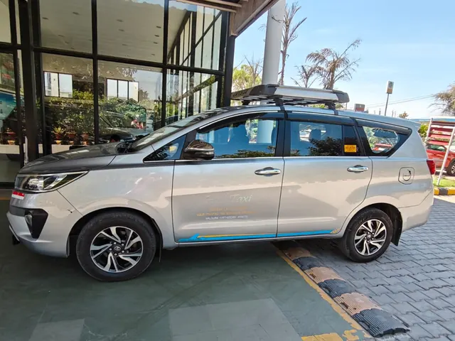 Silver Toyota Innova Crysta taxi, side view