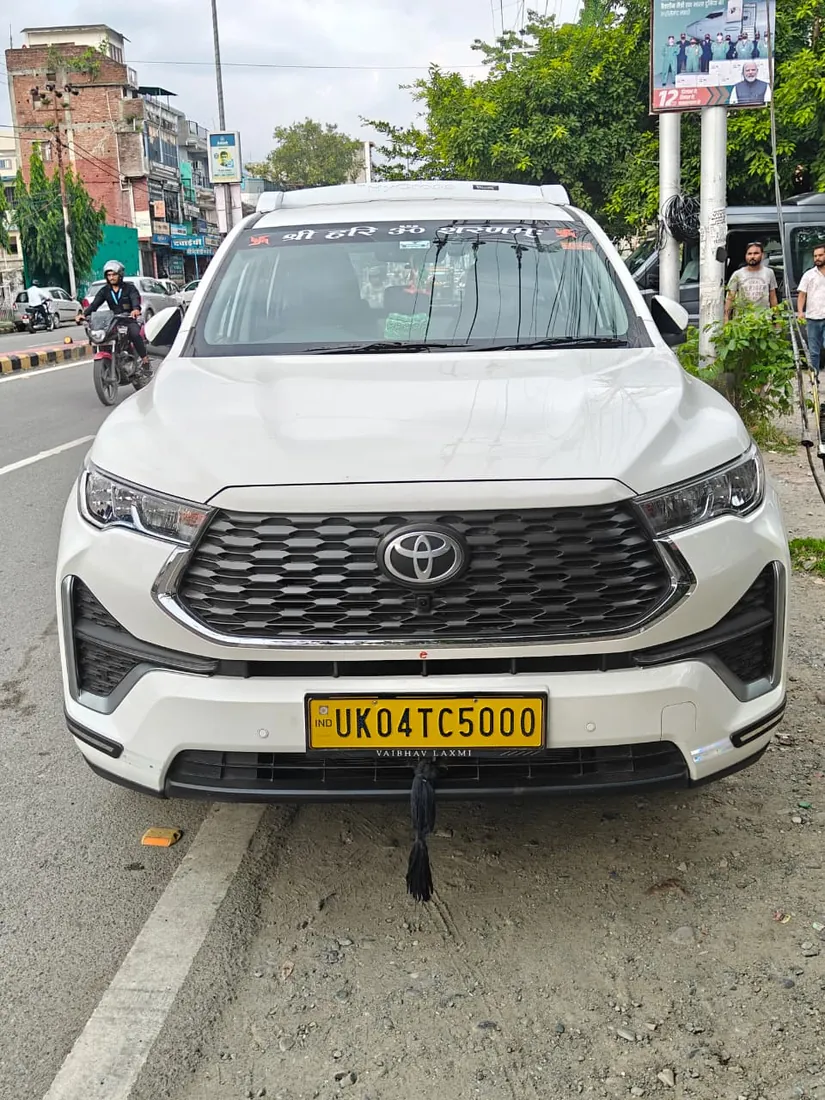 White Toyota Innova Hycross premium taxi, front view